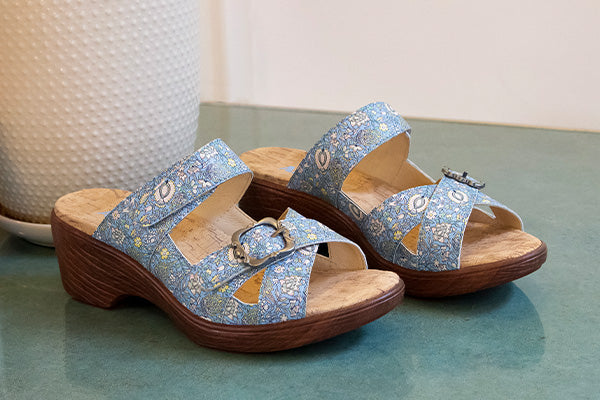 Sierra Smooth Jazz sandal on a lightweight wood-look wedge, with adjustable crisscross straps detailed with an ornate buckle.