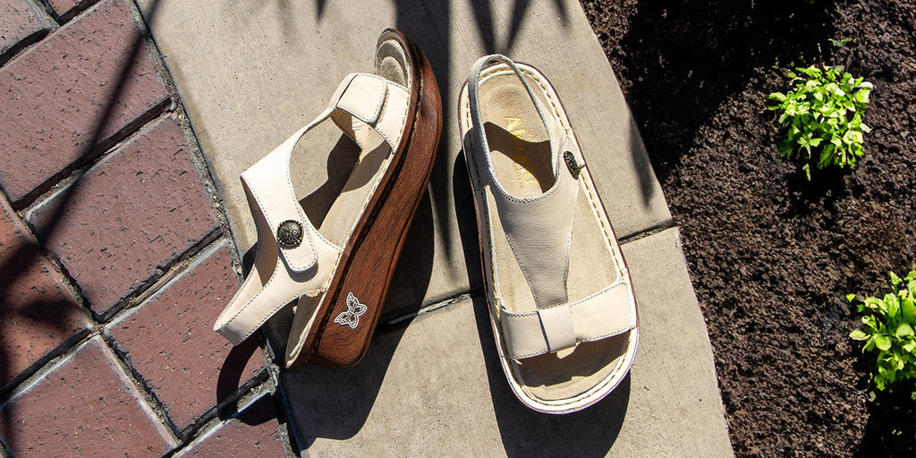 Kerri Ivory t-strap sandal on classic rocker outsole with patented removable footbed design.
