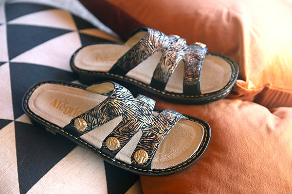 Venice slide on sandal with three hook-and-loop closures and leather uppers.
