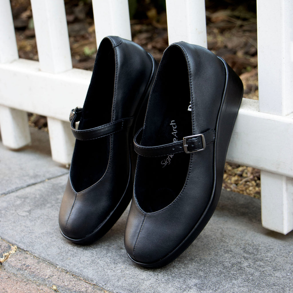 Haylo Black shoe on a Trimform wedge outsole |Black leather with a hook and loop strap.