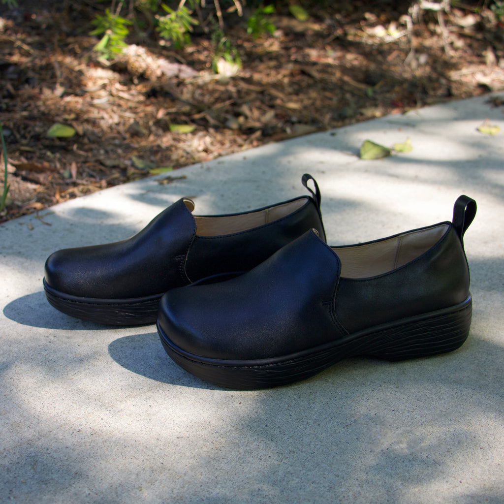 Orygin Black slip on style shoe on a Wood look rocker outsole