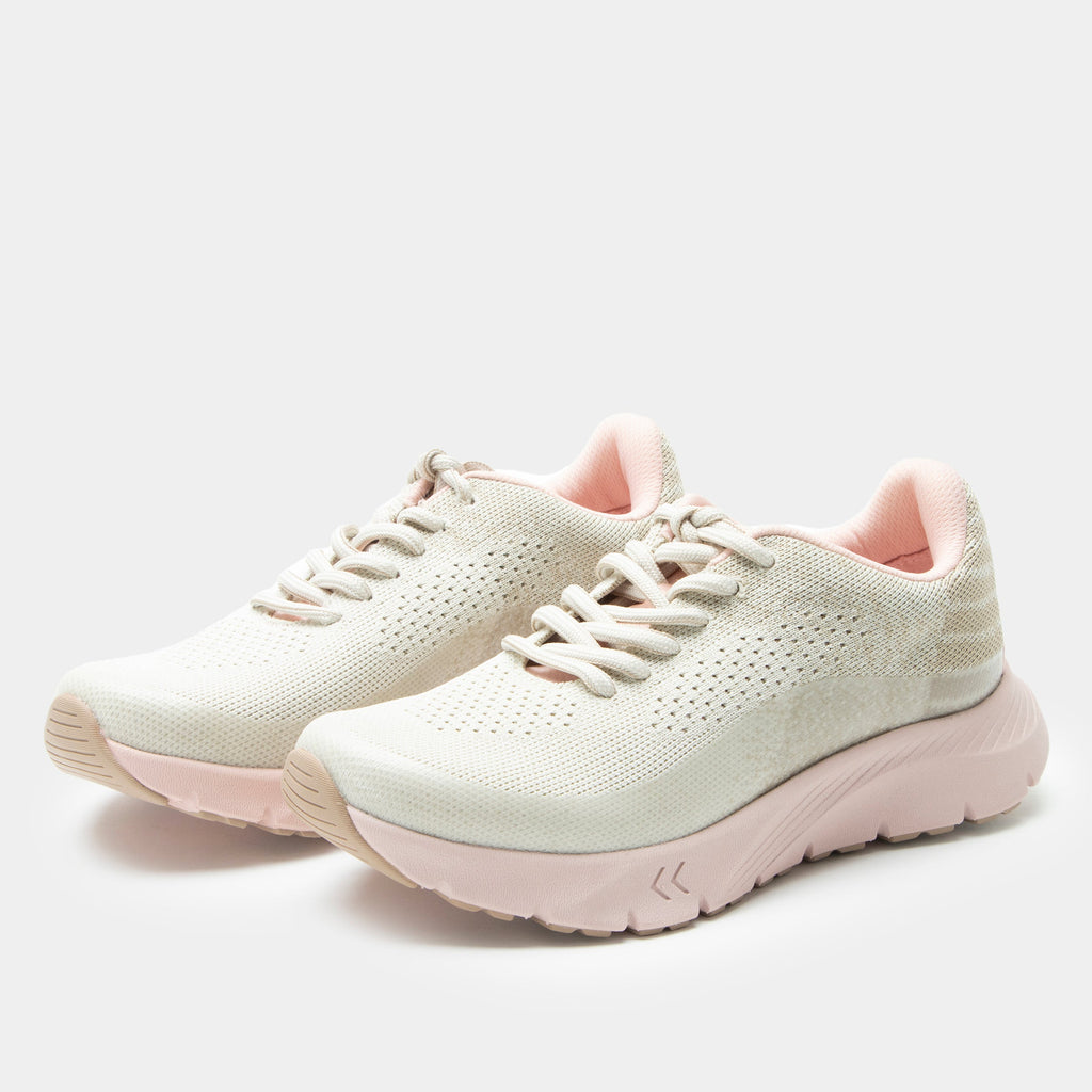 Revl Blush shoe on a lightweight EVA Rebounce outsole | Lace up shoe with a tan knit upper and pink outsole.