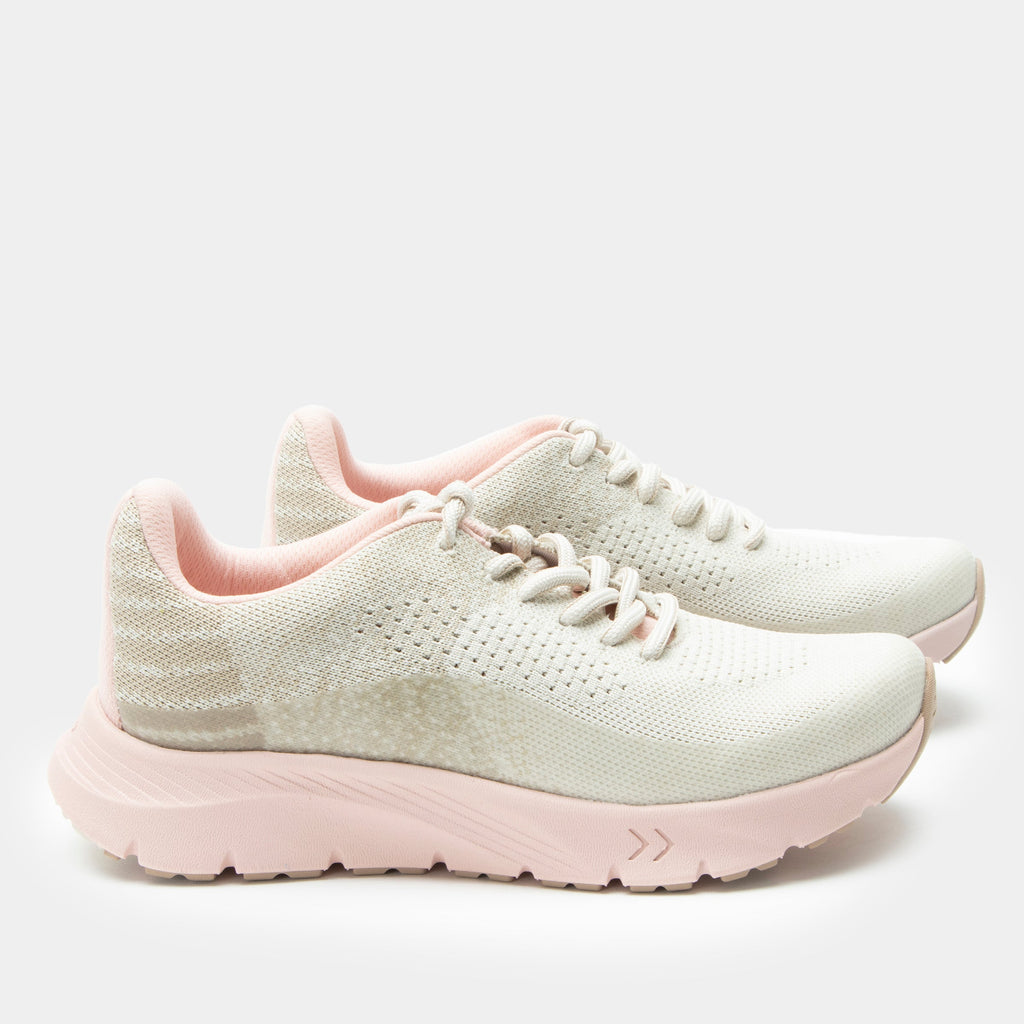 Revl Blush shoe on a lightweight EVA Rebounce outsole | Lace up shoe with a tan knit upper and pink outsole.