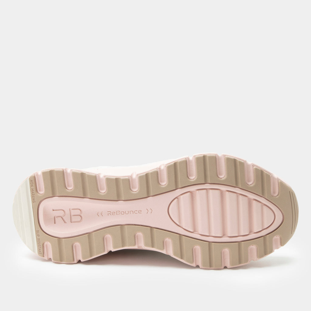 Revl Blush shoe on a lightweight EVA Rebounce outsole | Lace up shoe with a tan knit upper and pink outsole.