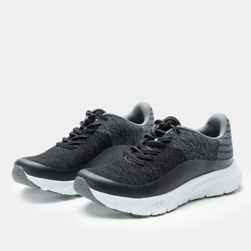 Revl Graphite shoe on a lightweight EVA Rebounce outsole | Lace up shoe with a black and grey knit upper and white outsole.