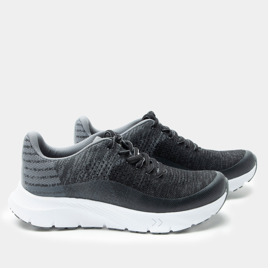 Revl Graphite shoe on a lightweight EVA Rebounce outsole | Lace up shoe with a black and grey knit upper and white outsole.