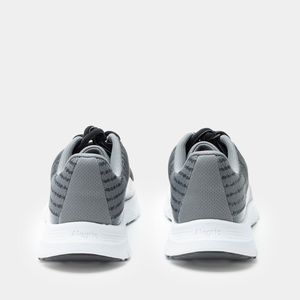 Revl Graphite shoe on a lightweight EVA Rebounce outsole | Lace up shoe with a black and grey knit upper and white outsole.