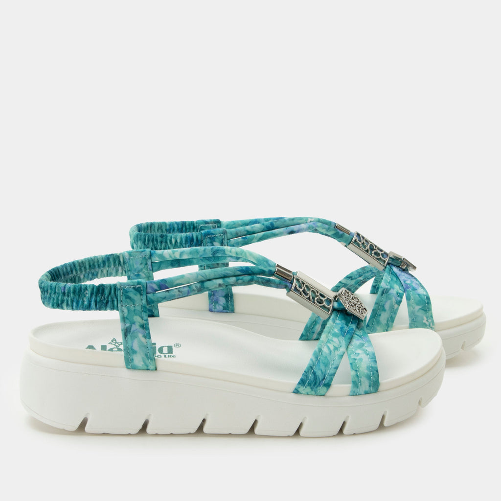 Roz Aqua Flora t-strap sandal | Blue braided vegan uppers and decorative sliver hardware.