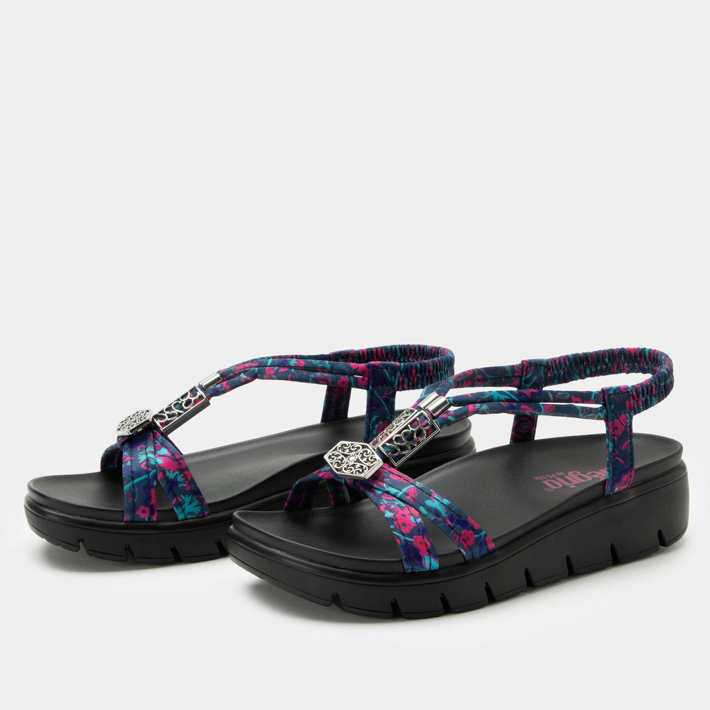 Roz Noche Flora t-strap sandal | Multi colored floral braided vegan uppers and decorative sliver hardware.