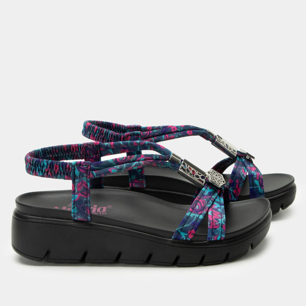 Roz Noche Flora t-strap sandal | Multi colored floral braided vegan uppers and decorative sliver hardware.