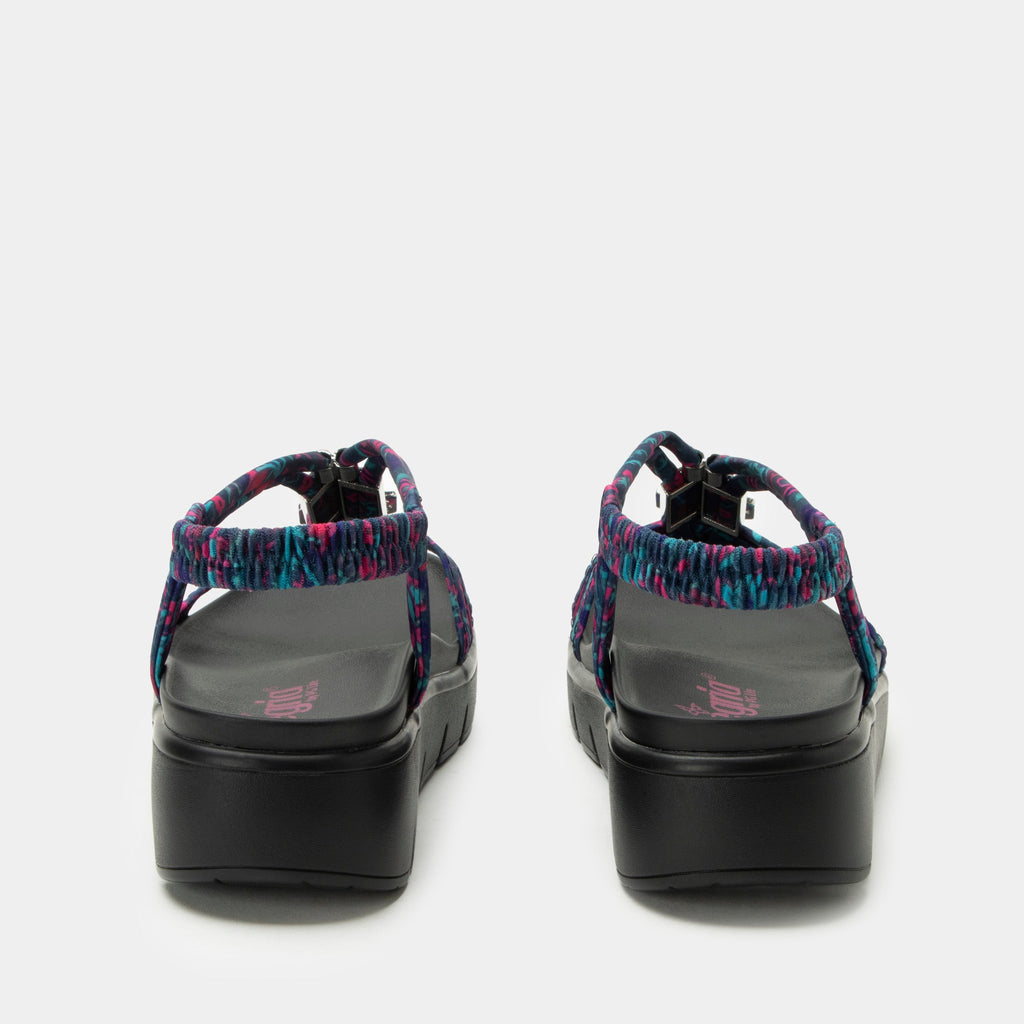 Roz Noche Flora t-strap sandal | Multi colored floral braided vegan uppers and decorative sliver hardware.