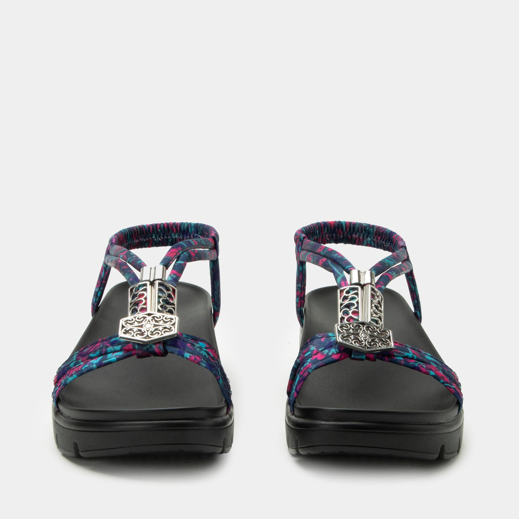 Roz Noche Flora t-strap sandal | Multi colored floral braided vegan uppers and decorative sliver hardware.