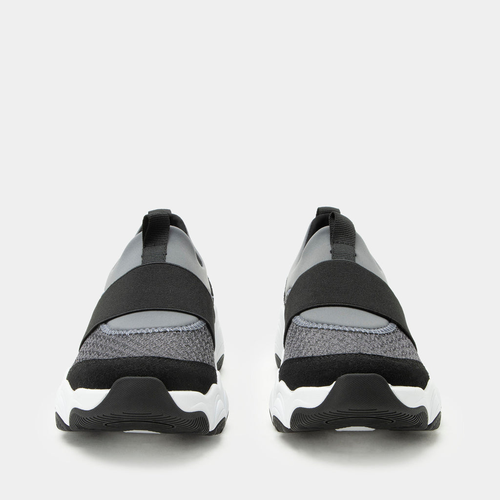 Sleek Joy Slate Grey shoe on a lightweight EVA Boom Joy outsole. | Grey slip-on shoe with black details and an elastic vamp strap.