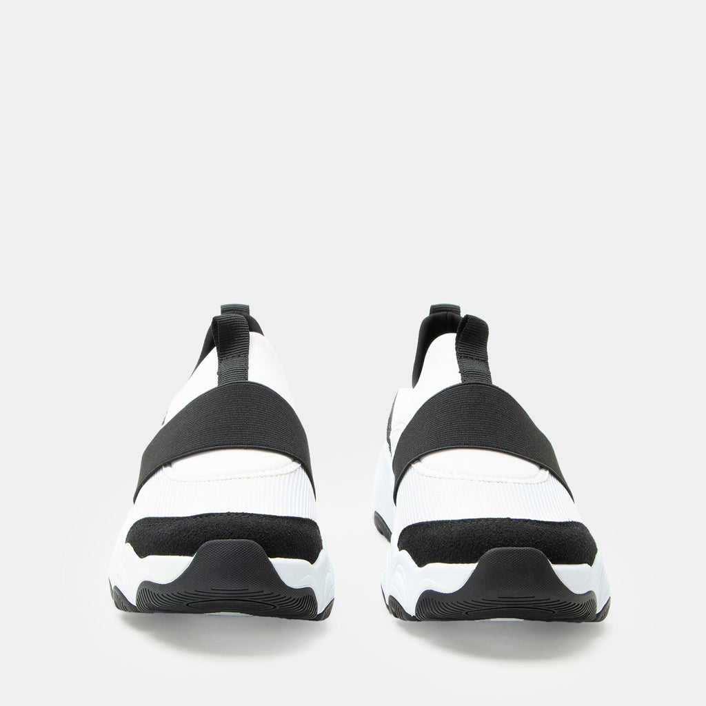 Sleek Joy Panda shoe on a lightweight EVA Boom Joy outsole | White slip-on shoe with black details and an elastic vamp strap.