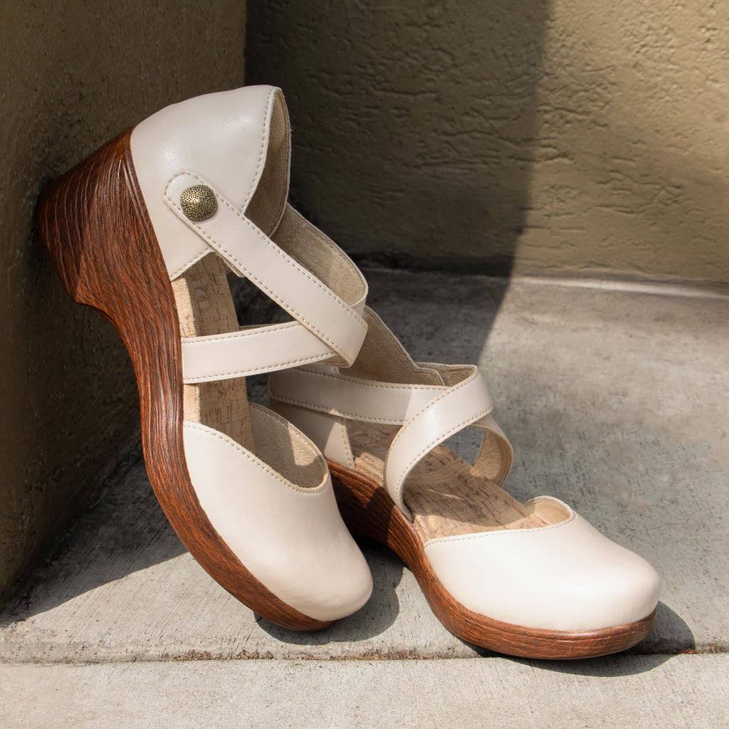 Savina Oat shoe with an adjustable strap on a wood look wedge outsole | Cream colored mary jane style shoe on a wedge.