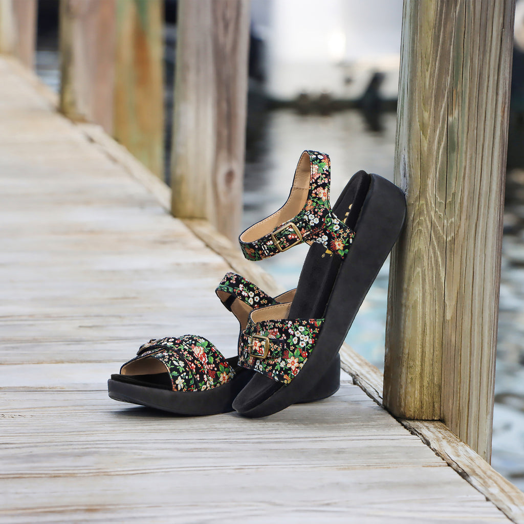 Ladylike charm defines this Maryn leather sandal with adjustable hook-and-loop straps at the vamp and instep that's trimmed with decorative buckles.X